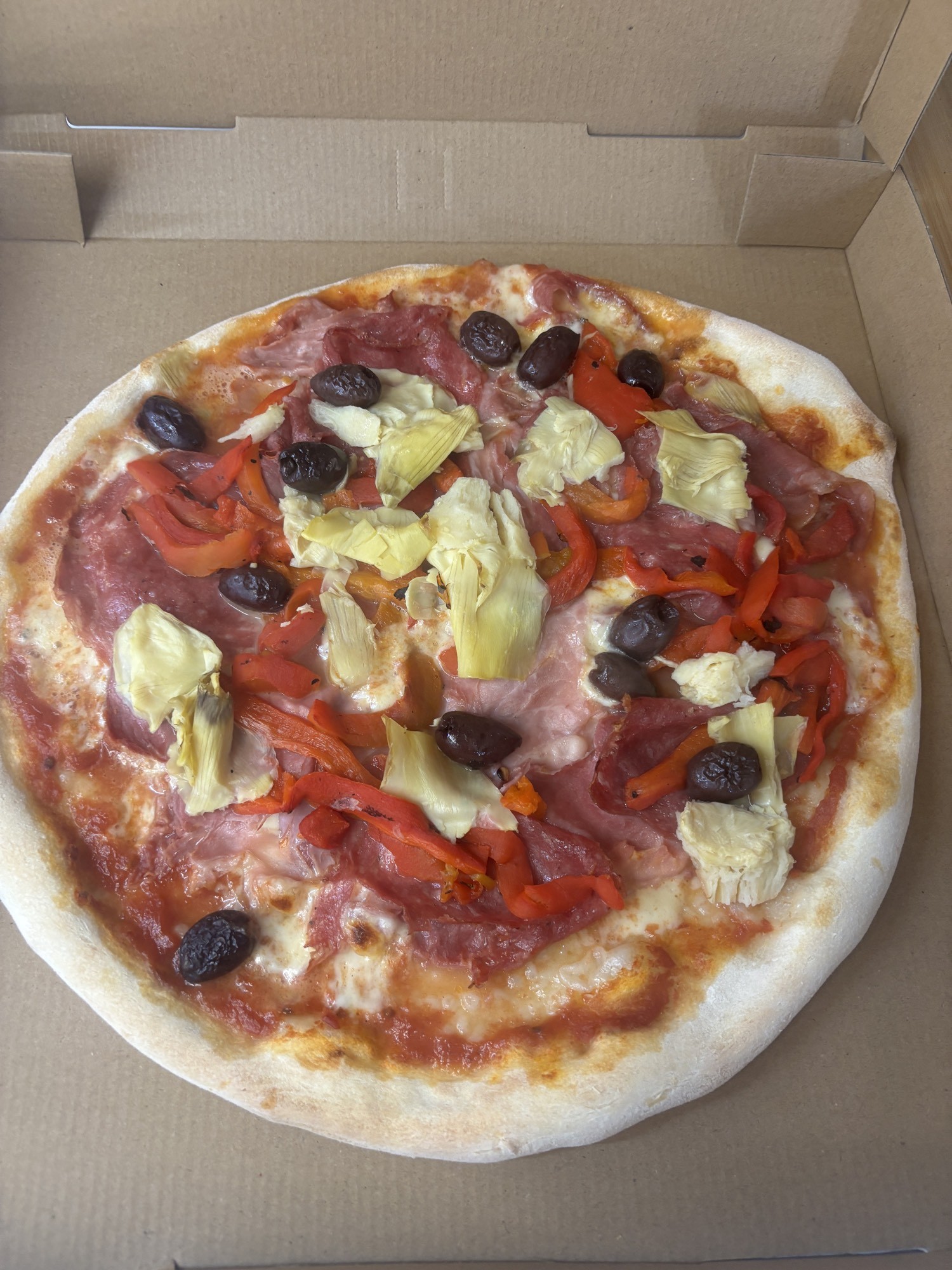 Sweet Life loaded pizza with salami, ham, artichokes and olives